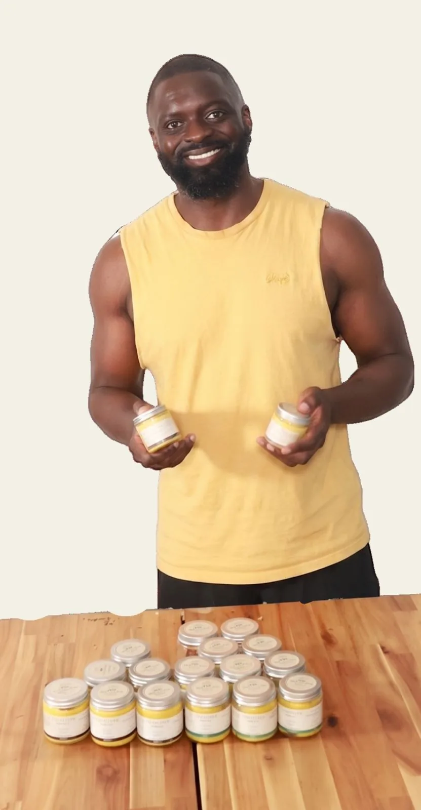 The founder smiling and holding two jars of SANOOSI body butter