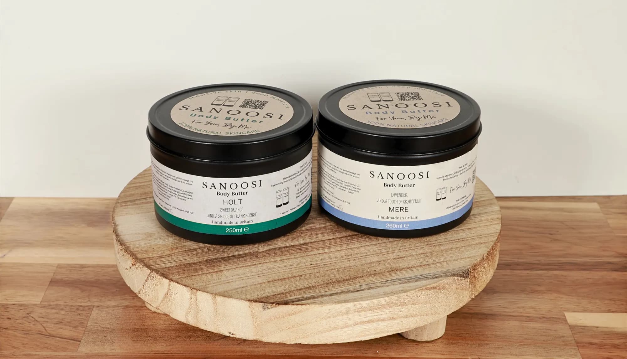 Large tins of HOLT and MERE body butter side by side